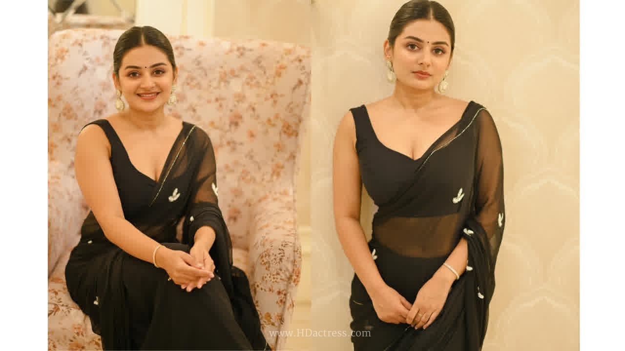 Esther anil looks trendy in a graceful black sleeveless saree..