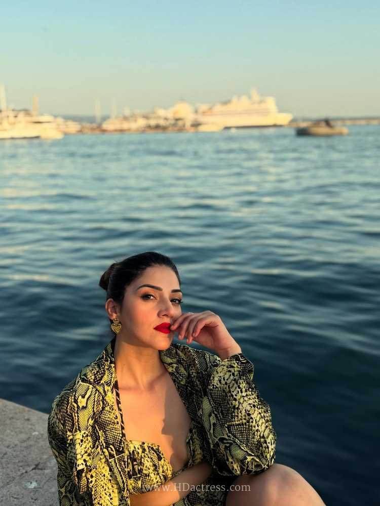 Candid viral shot of South Indian star Mehreen Pirzada enjoying a sunny day poolside, flaunting her curves in a colorful summer bikini.