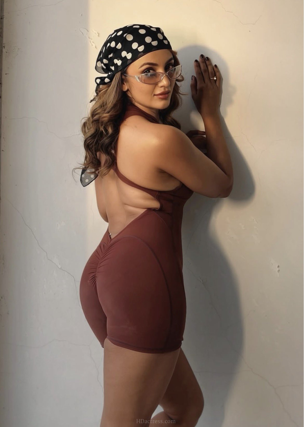 Tejaswi Madivada flaunting her curves in a dramatic low V-back sleeveless bodycon dress during a bold photoshoot.
