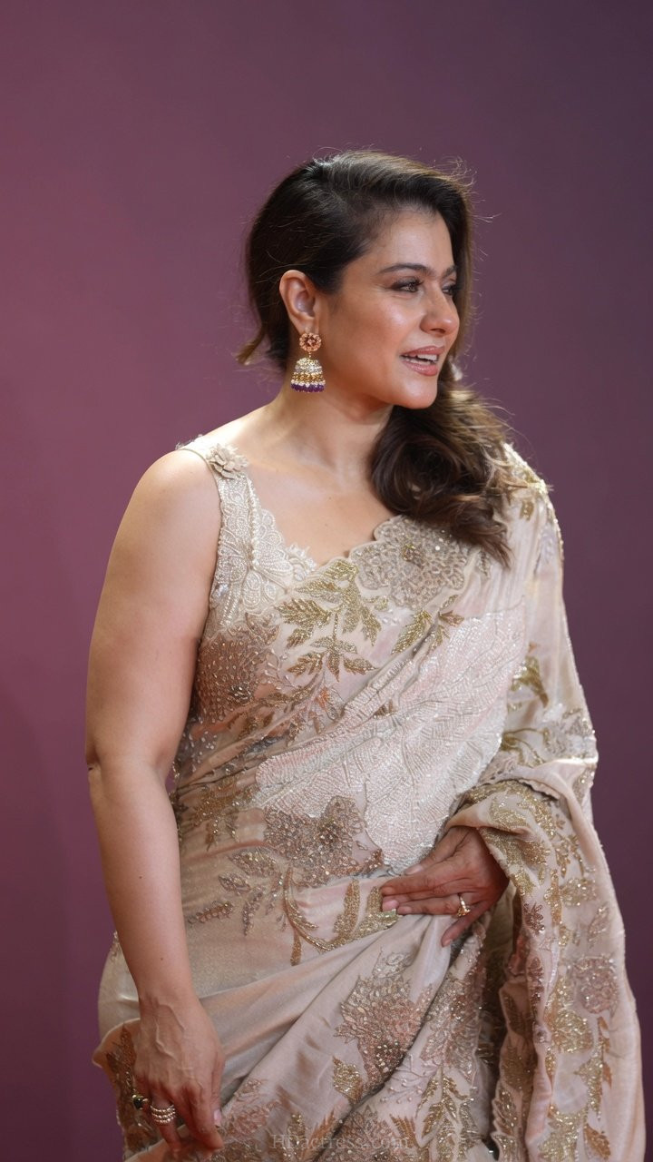Close-up shot of Bollywood actress Kajol Devgan flaunting a stylish sleeveless blouse with intricate embroidery work.