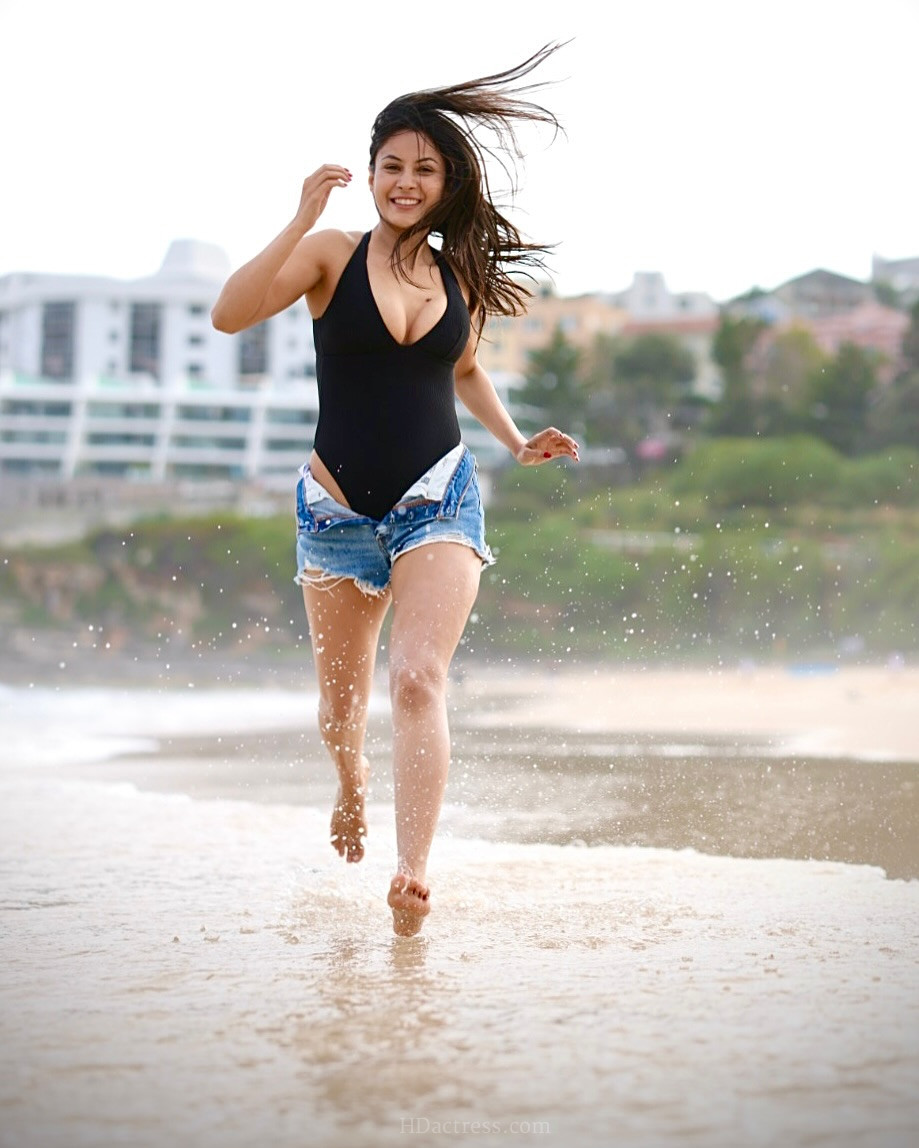 Where can I buy the exact black deep V-neck one-piece swimsuit Shehnaaz Gill wore in her latest viral beach photos?