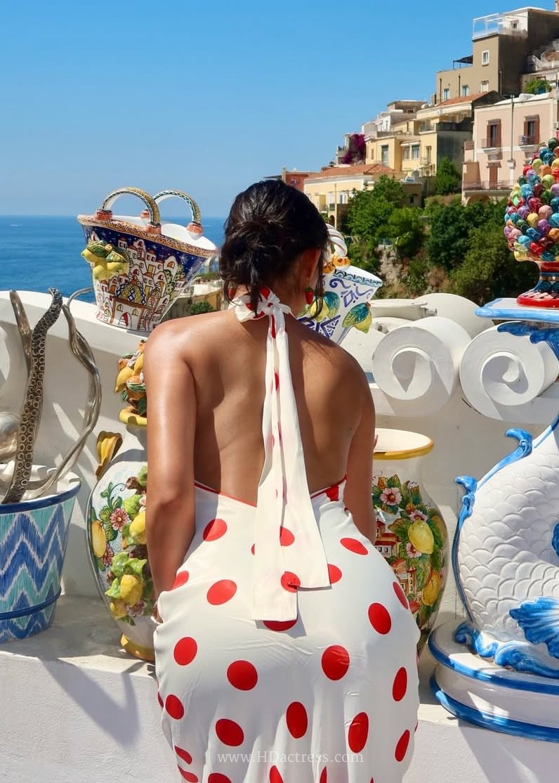 Reality star Kashish Kapoor posing in a daring backless designer gown at a high-profile fashion event.
