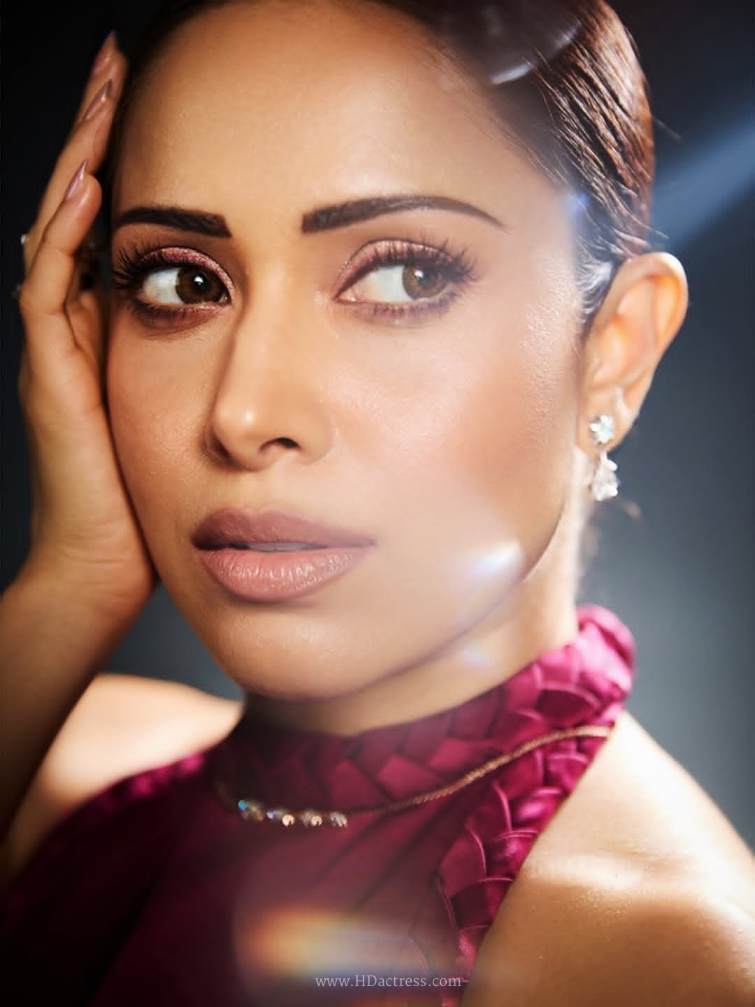 Bold portrait of Bollywood star Nushrratt Bharuccha showcasing a high-fashion makeup look and elegant style.