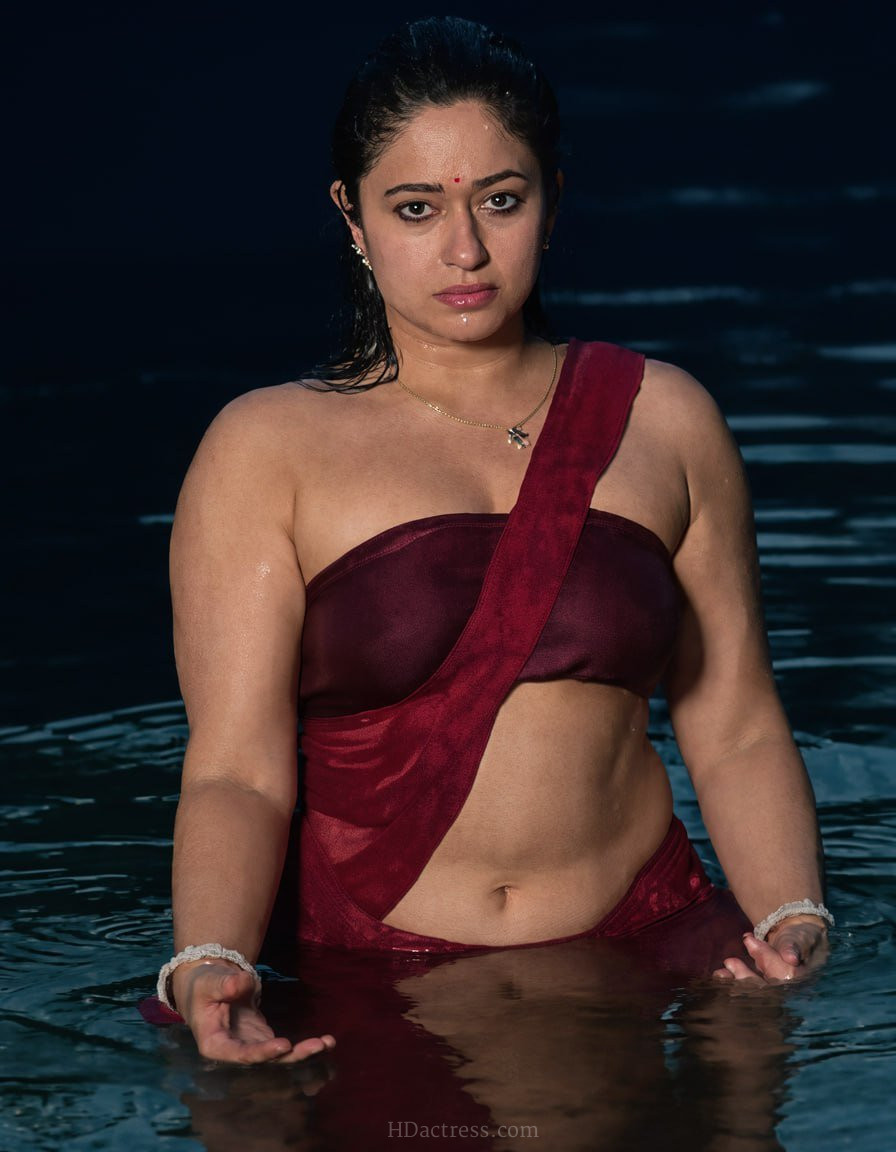 South Indian actress Poonam Bajwa flaunting a stunning wet navel look in a vibrant red blouse during a dramatic sequence in Sshhh 3.