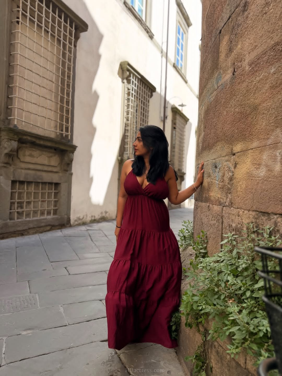 Indian actress Rajisha Vijayan looking stunning in a chic emerald green spaghetti strap dress with a low open back design.