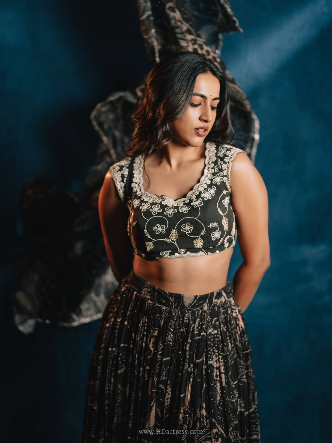 Close up portrait of actress Niharika Konidela wearing a designer black silk embroidered blouse.