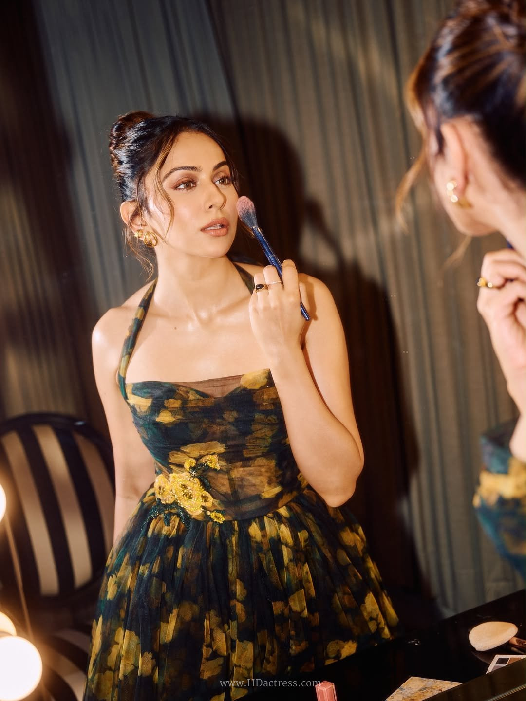 Full-length portrait of actress Rakul Preet Singh styling a designer plunging neckline maxi dress.