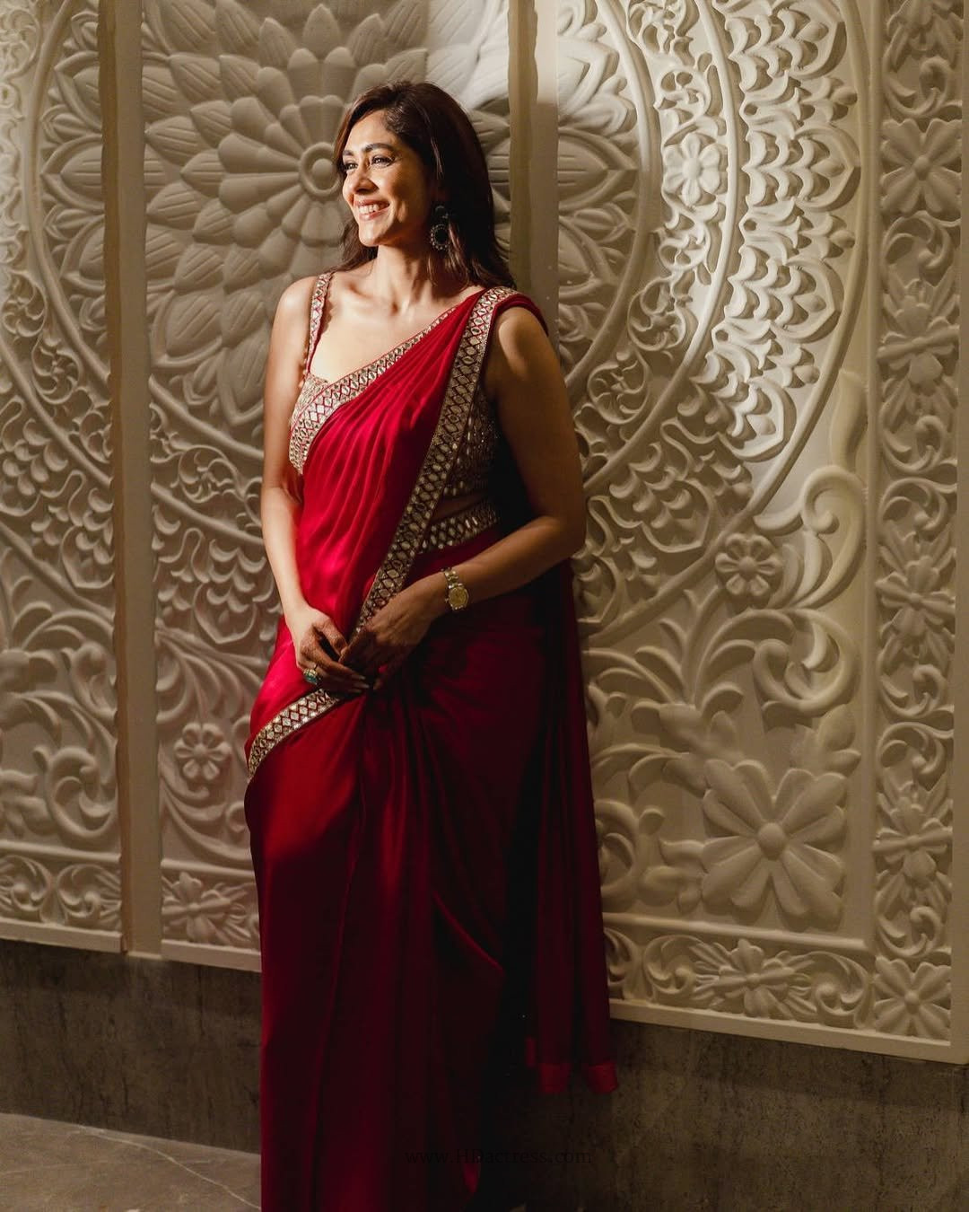 Actress Mrunal Thakur exuding grace and confidence while flaunting a heavily detailed red saree.