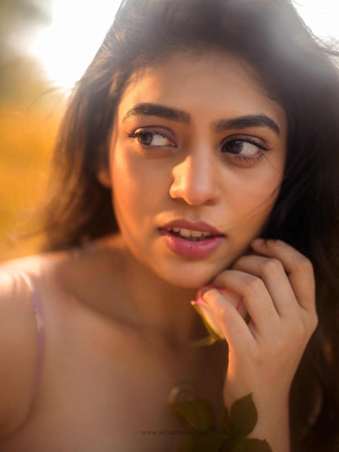 Actress Bandhavi Sridhar posing in a glamorous close-up portrait highlighting her sharp facial features