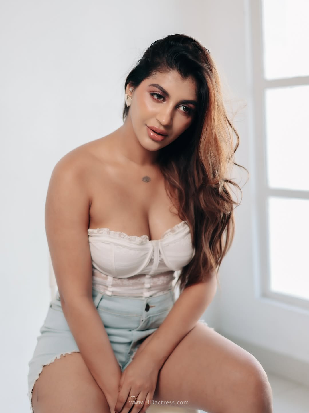 Yashika Aannand looking glamorous and bold in a tight white lace strapless corset top.