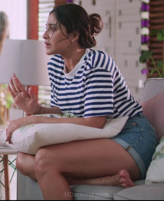 Regina Cassandra posing in a bold backless designer dress highlighting her toned back and thighs.
