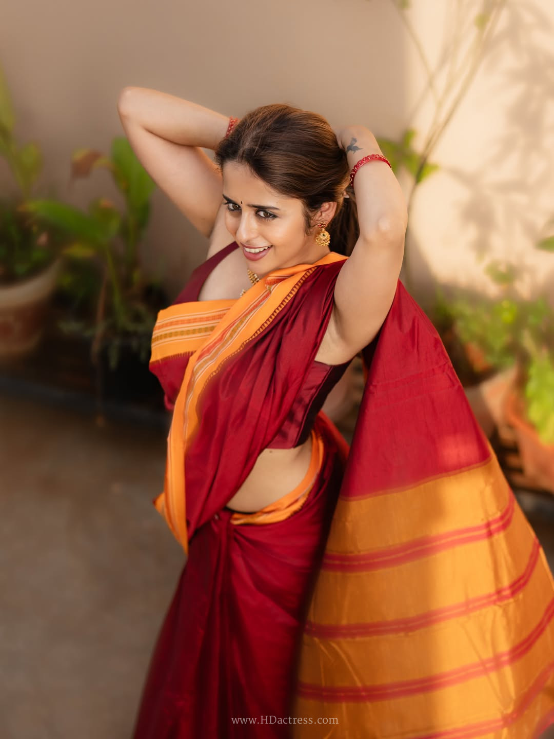 ravallika Damerla in maroon handloom silk saree