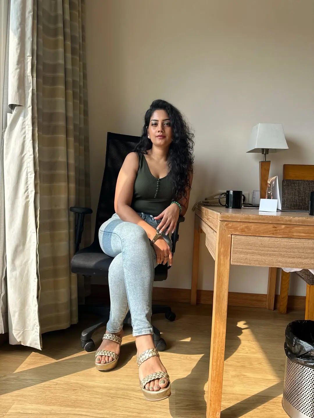 Beautiful Tollywood Actress Karuna Bhushan Stills In Green Top Blue Jeans - Image 1