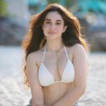 Aditi Budhathoki in white beachwear with blue patterned sarong