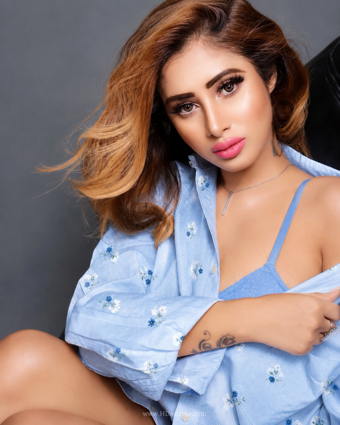 Jiya Roy in light blue striped floral shirt