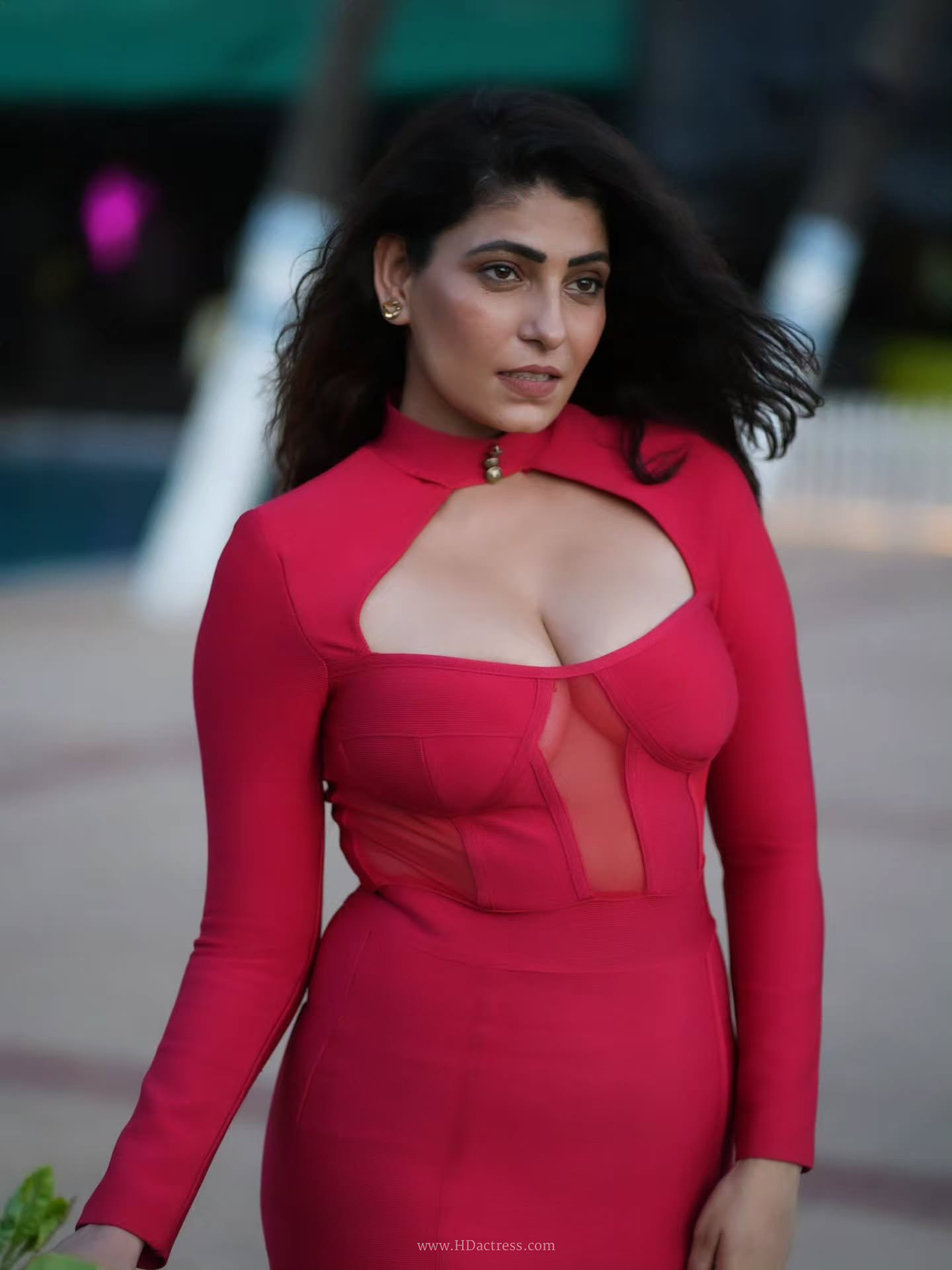 Nikita Soni posing in a sheer red mesh lace flattering corset bodice with a subtle side bust show.