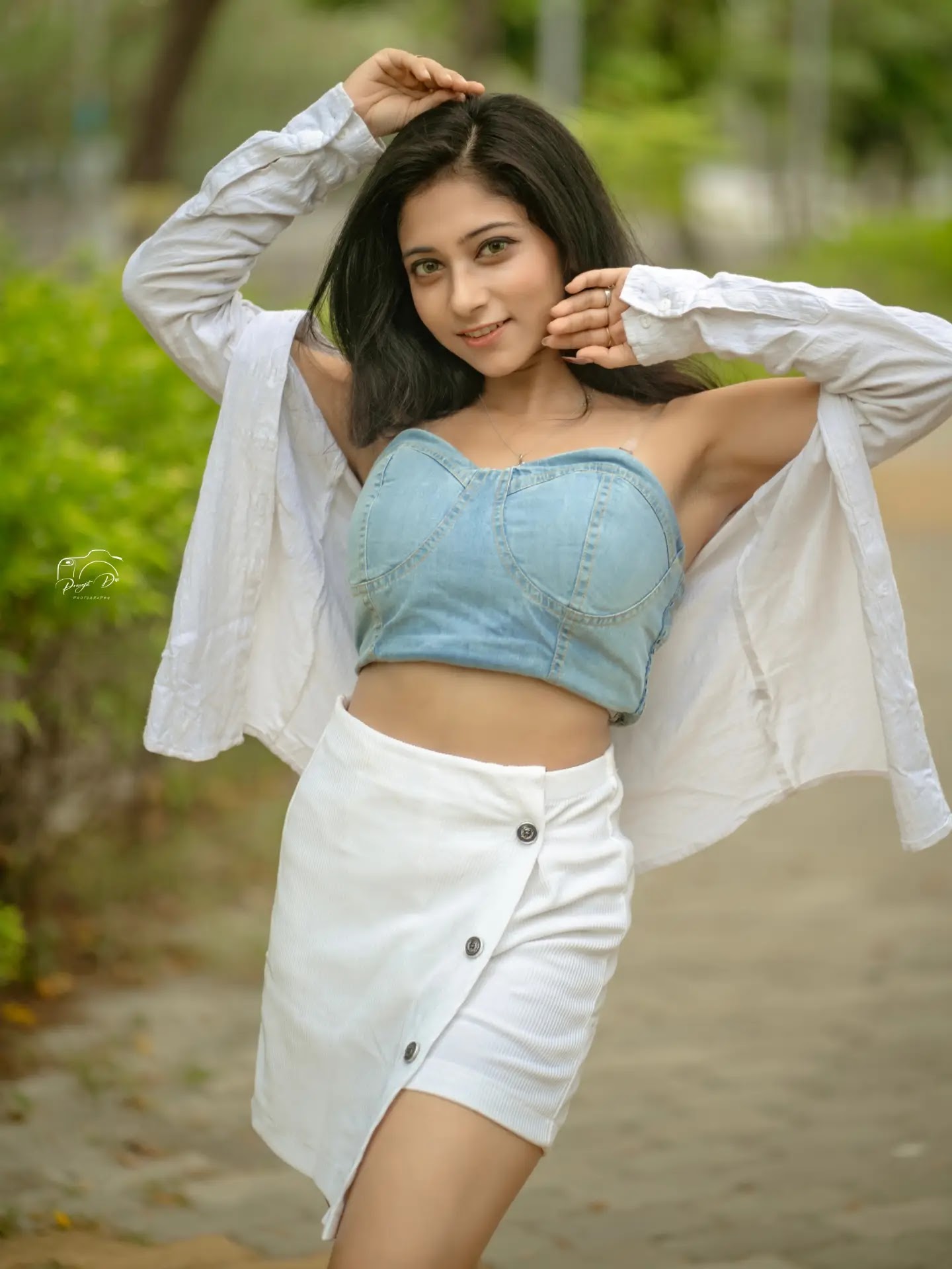 Puja Chakraborty in denim crop top and white wrap skirt