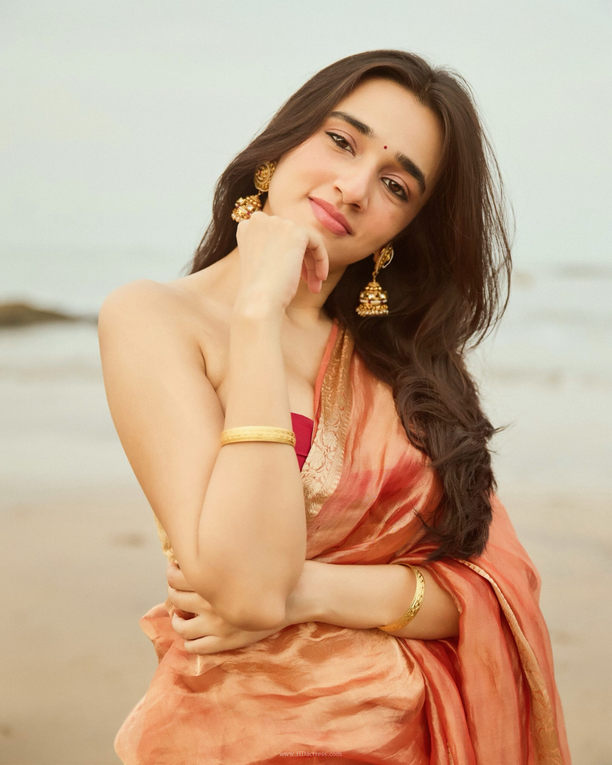 Nuveksha in orange silk saree with gold border Nuveksha in orange silk saree with gold border