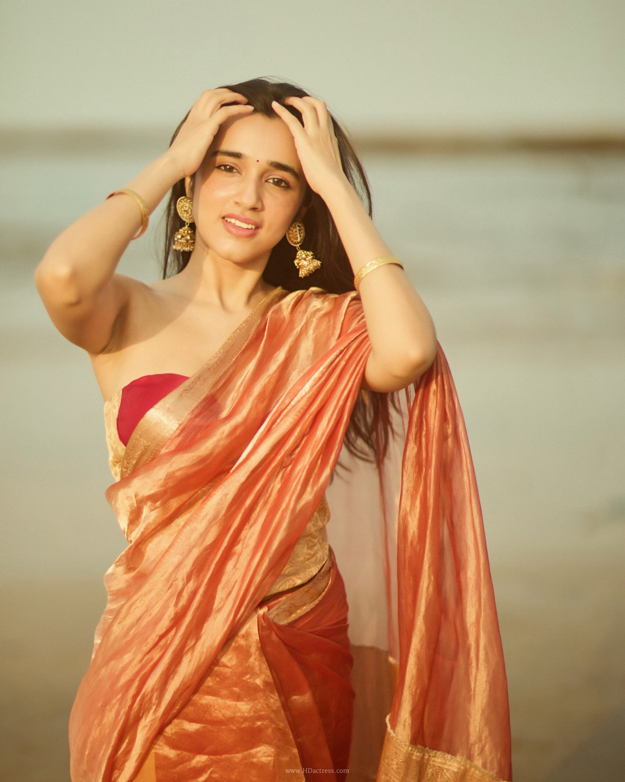 Nuveksha in orange silk saree with gold border Nuveksha in orange silk saree with gold border