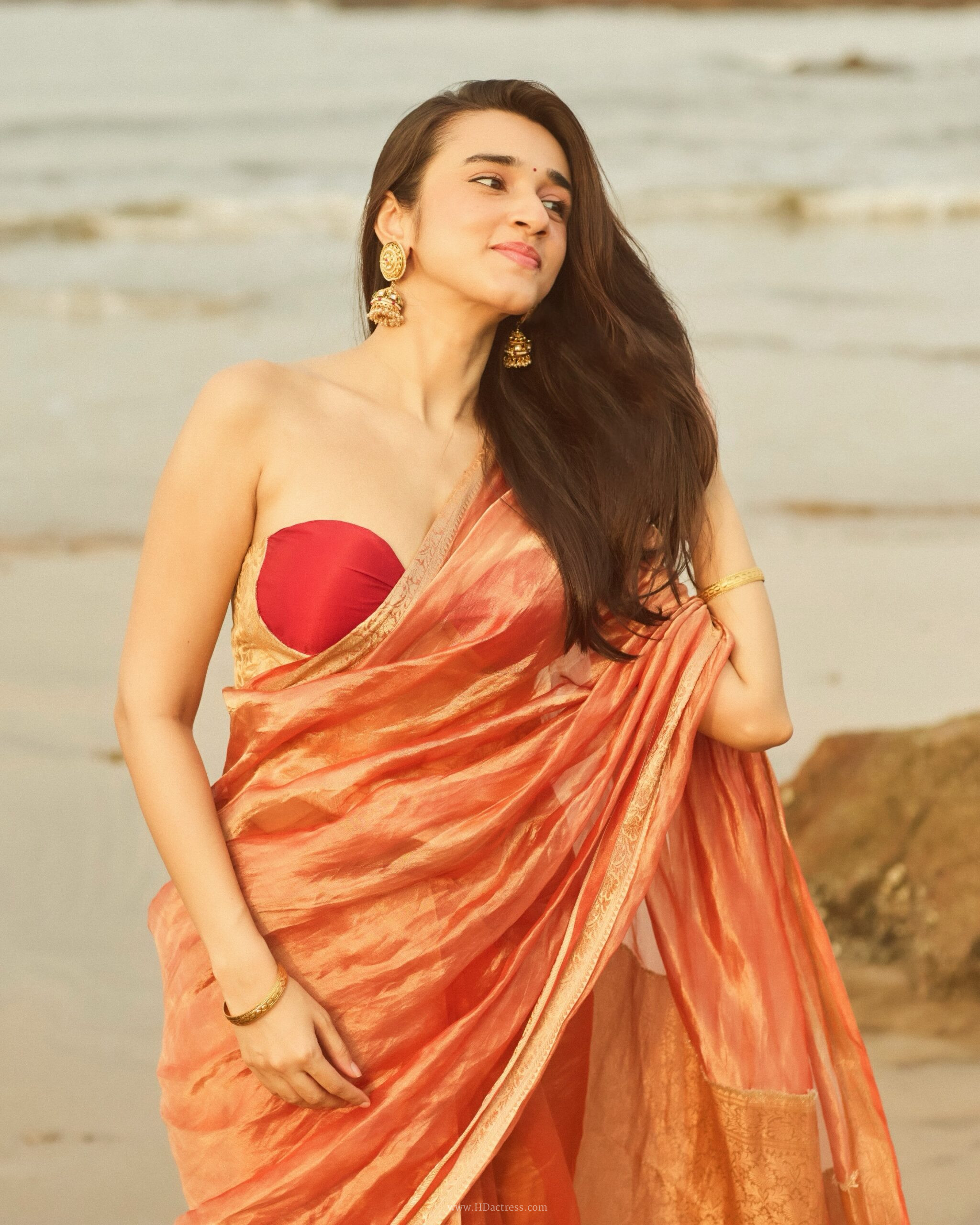 Nuveksha in orange silk saree with gold border Nuveksha in orange silk saree with gold border