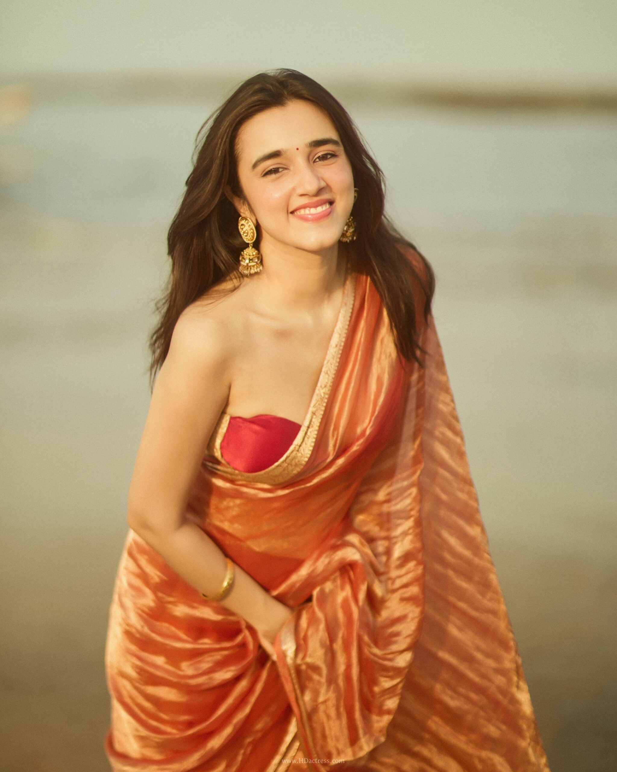 Nuveksha in orange silk saree with gold border Nuveksha in orange silk saree with gold border