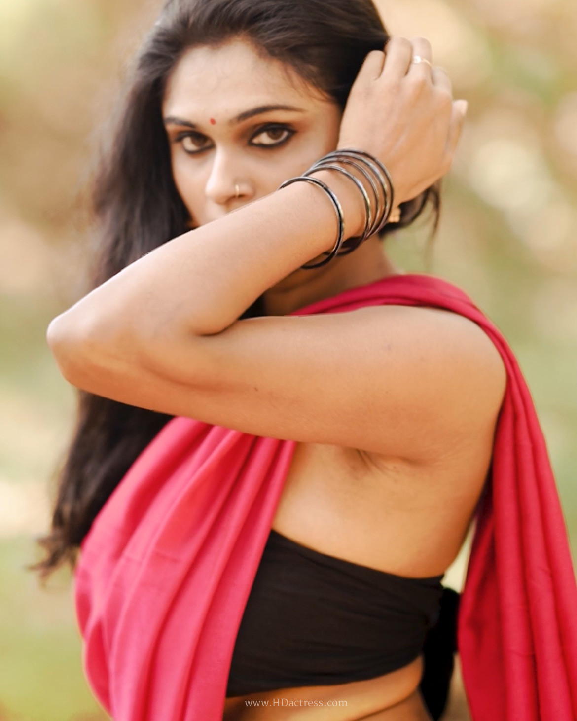 Remya Velayudhan in vibrant red saree