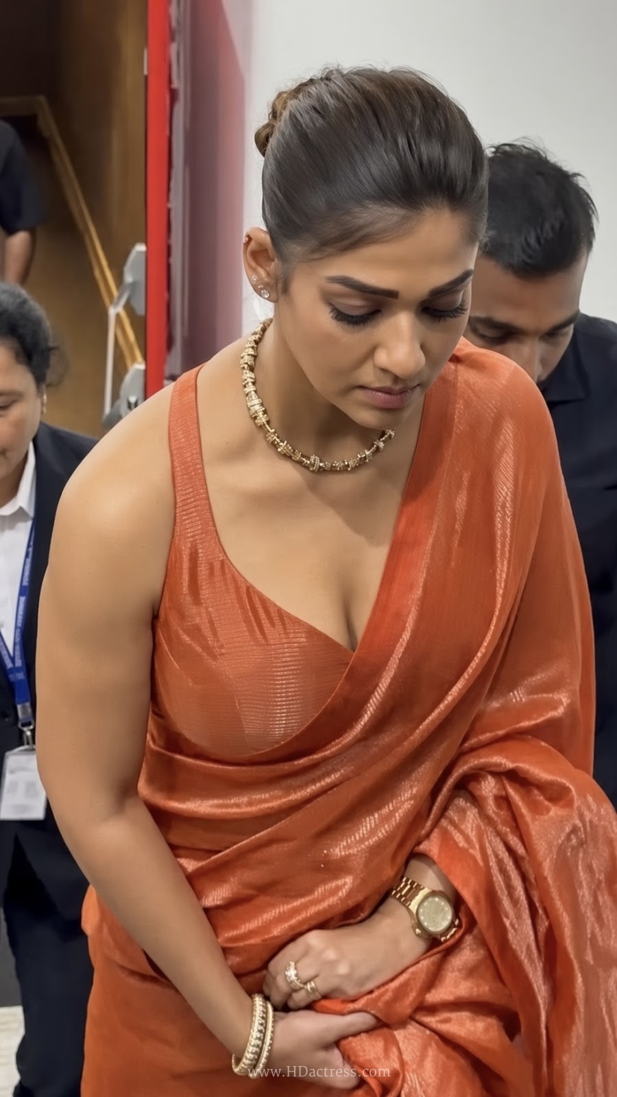 Nayanthara Looks Elegant in Orange Saree at Toxic Movie Trailer Launch – Photos - Image 9 Nayanthara bun hairstyle orange saree