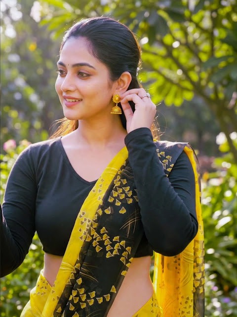 Zayana Vaani in yellow printed saree and black blouse