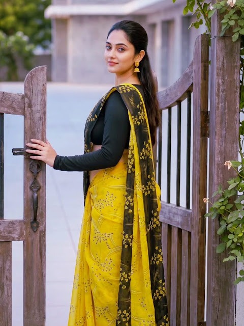 Zayana Vaani in yellow printed saree and black blouse