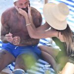 Pinned: David and Victoria Beckham shared a tender moment while relaxing on a sun lounger during their Italian getaway on the Amalfi Coast.