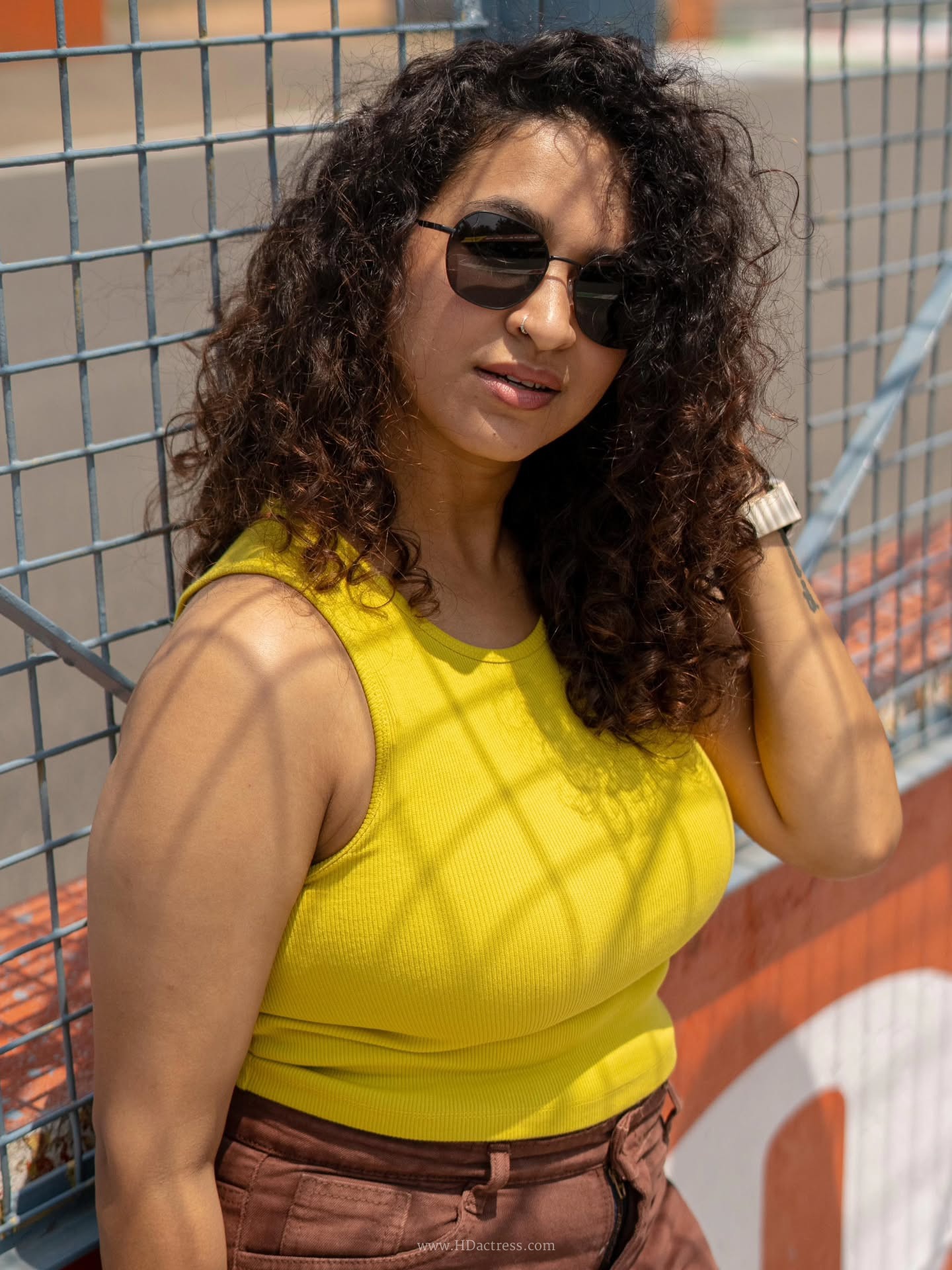 Close-up portrait of Misha Ghoshal featuring natural makeup and casual wardrobe styling.