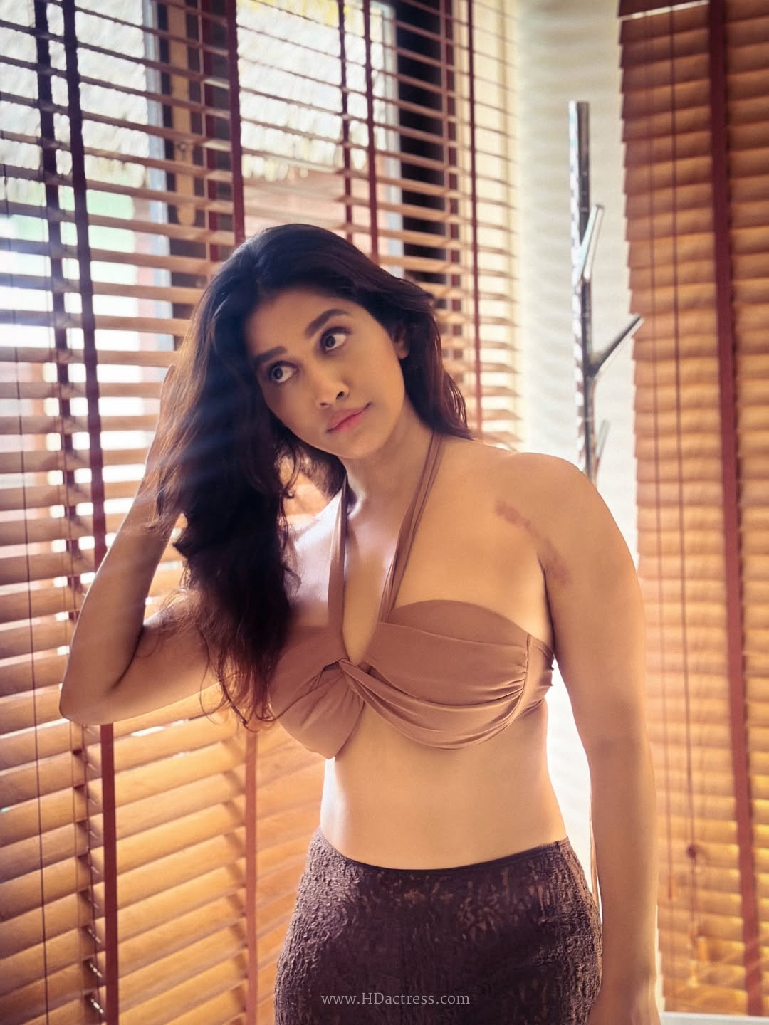 Nabha Natesh stands 5 feet 6 inches, weighs around 55 kg, with body measurements of 34-24-35 and bra size 34B.
