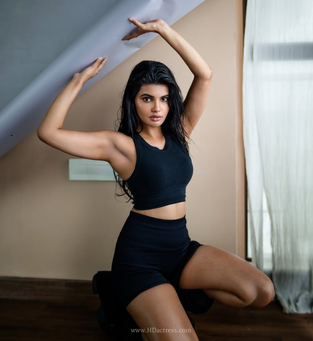 Richa Ravi Sinha wearing a black cropped tank top and athletic shorts Richa Ravi Sinha wearing a black cropped tank top and athletic shorts
