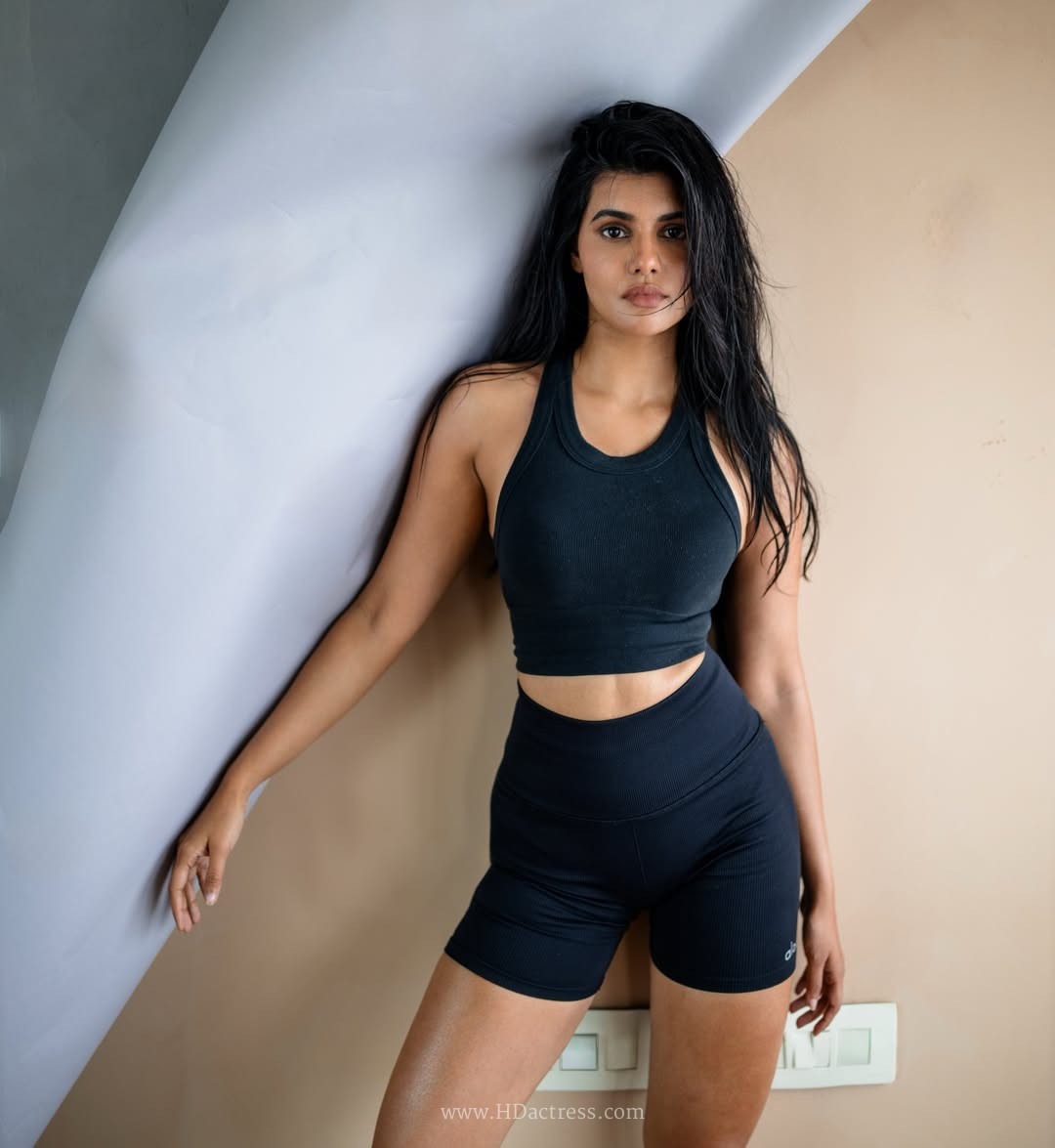 Richa Ravi Sinha wearing a black cropped tank top and athletic shorts Richa Ravi Sinha wearing a black cropped tank top and athletic shorts