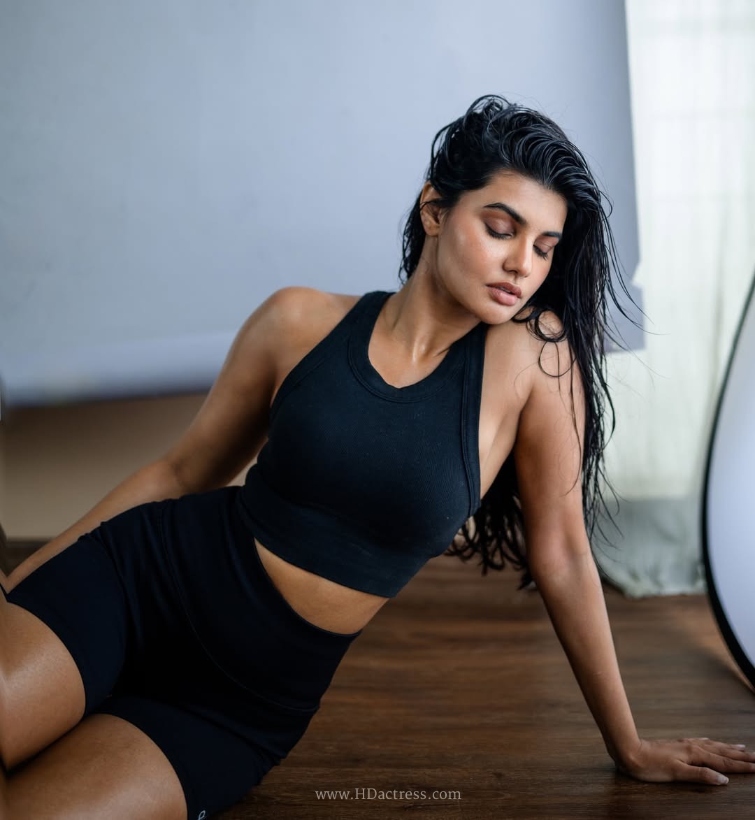 Richa Ravi Sinha wearing a black cropped tank top and athletic shorts Richa Ravi Sinha wearing a black cropped tank top and athletic shorts