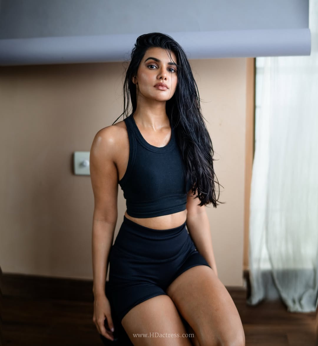 Richa Ravi Sinha wearing a black cropped tank top and athletic shorts Richa Ravi Sinha wearing a black cropped tank top and athletic shorts