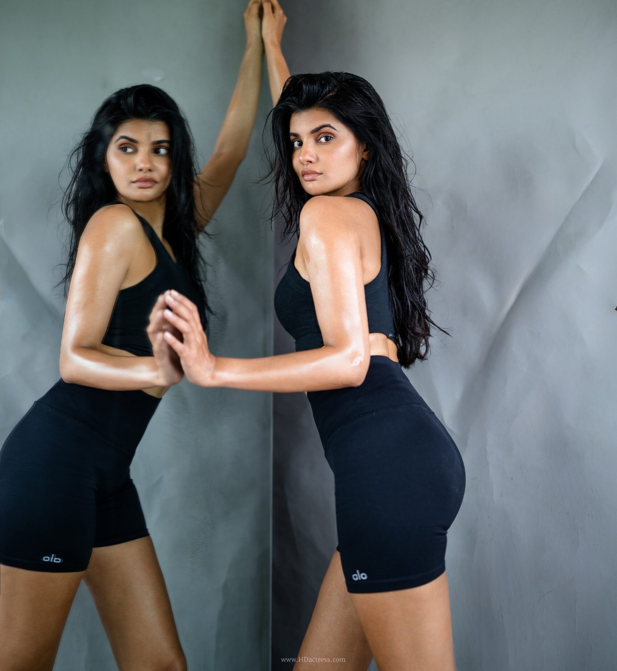 Richa Ravi Sinha wearing a black cropped tank top and athletic shorts Richa Ravi Sinha wearing a black cropped tank top and athletic shorts