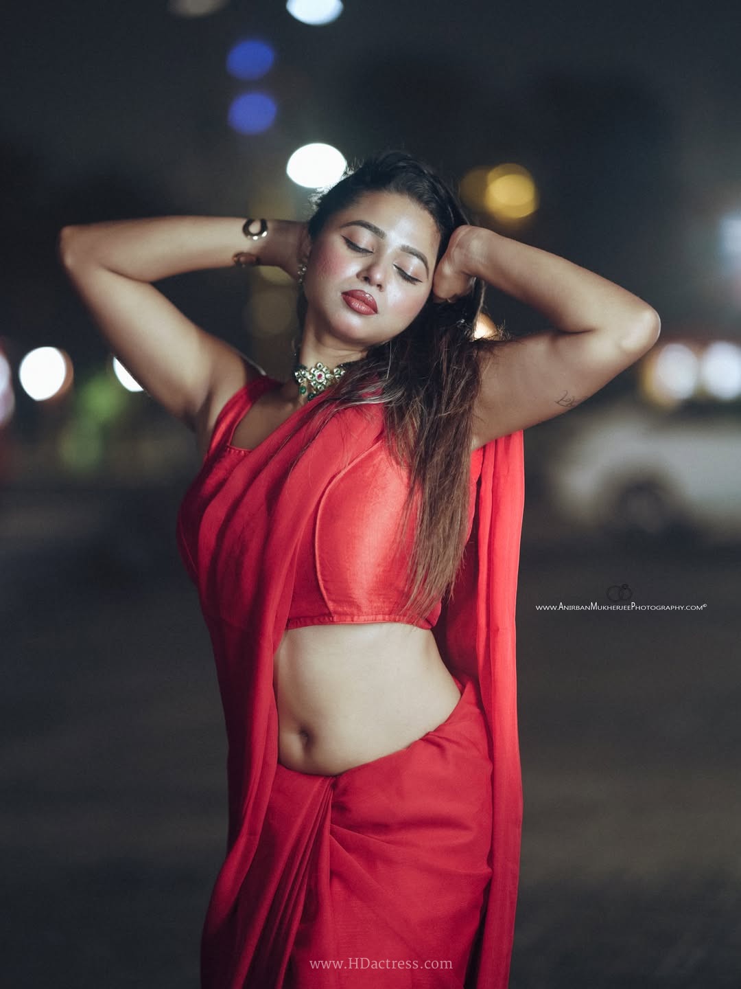 Shipra Tarafder wearing a crimson red saree and matching sleeveless blouse