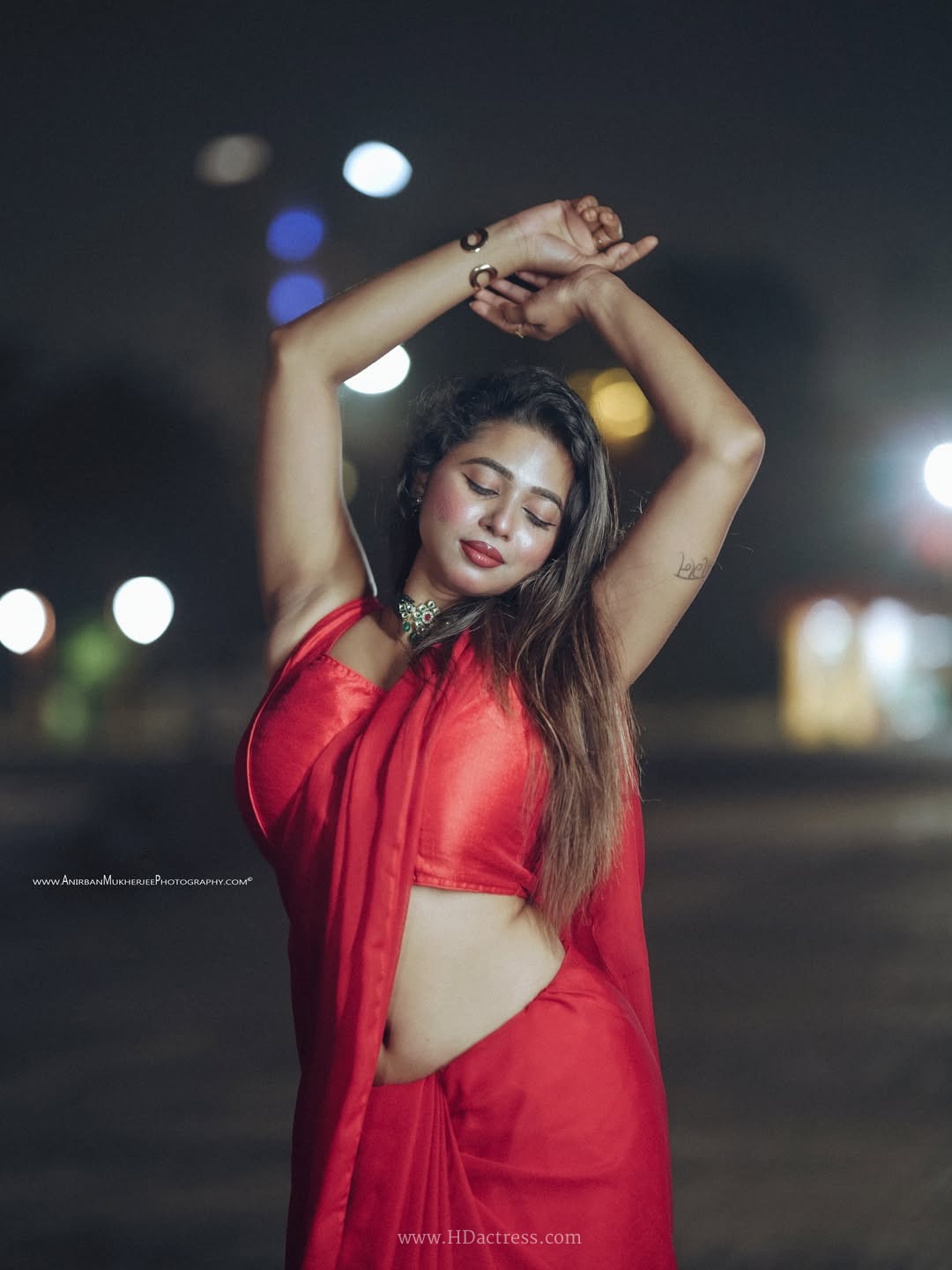 Shipra Tarafder wearing a crimson red saree and matching sleeveless blouse