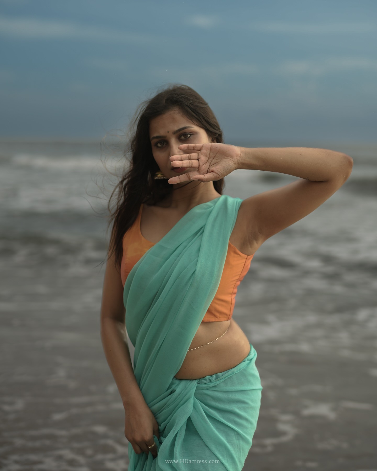 Srishti Singh wearing a mint green chiffon saree and peach-orange blouse