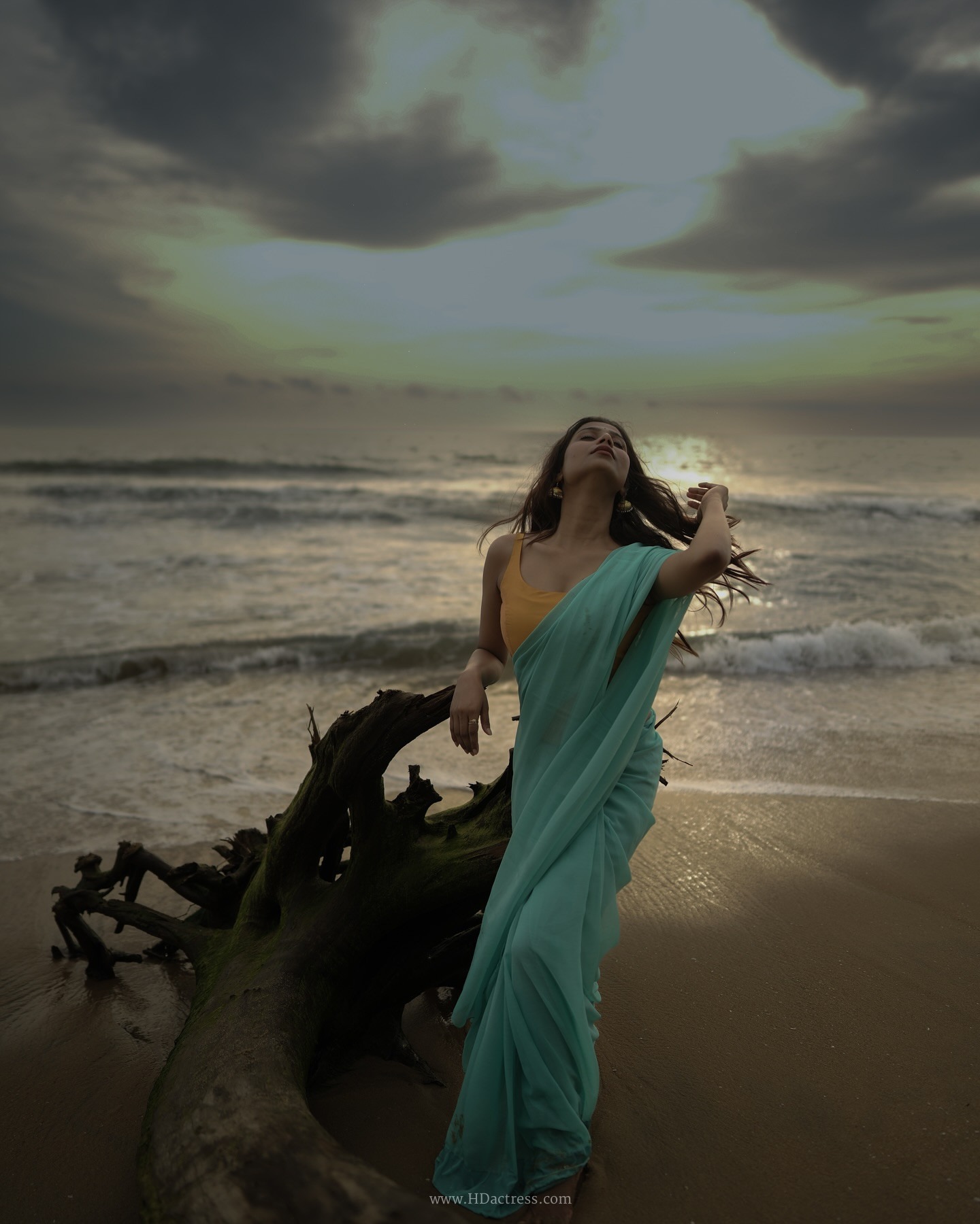 Srishti Singh wearing a mint green chiffon saree and peach-orange blouse