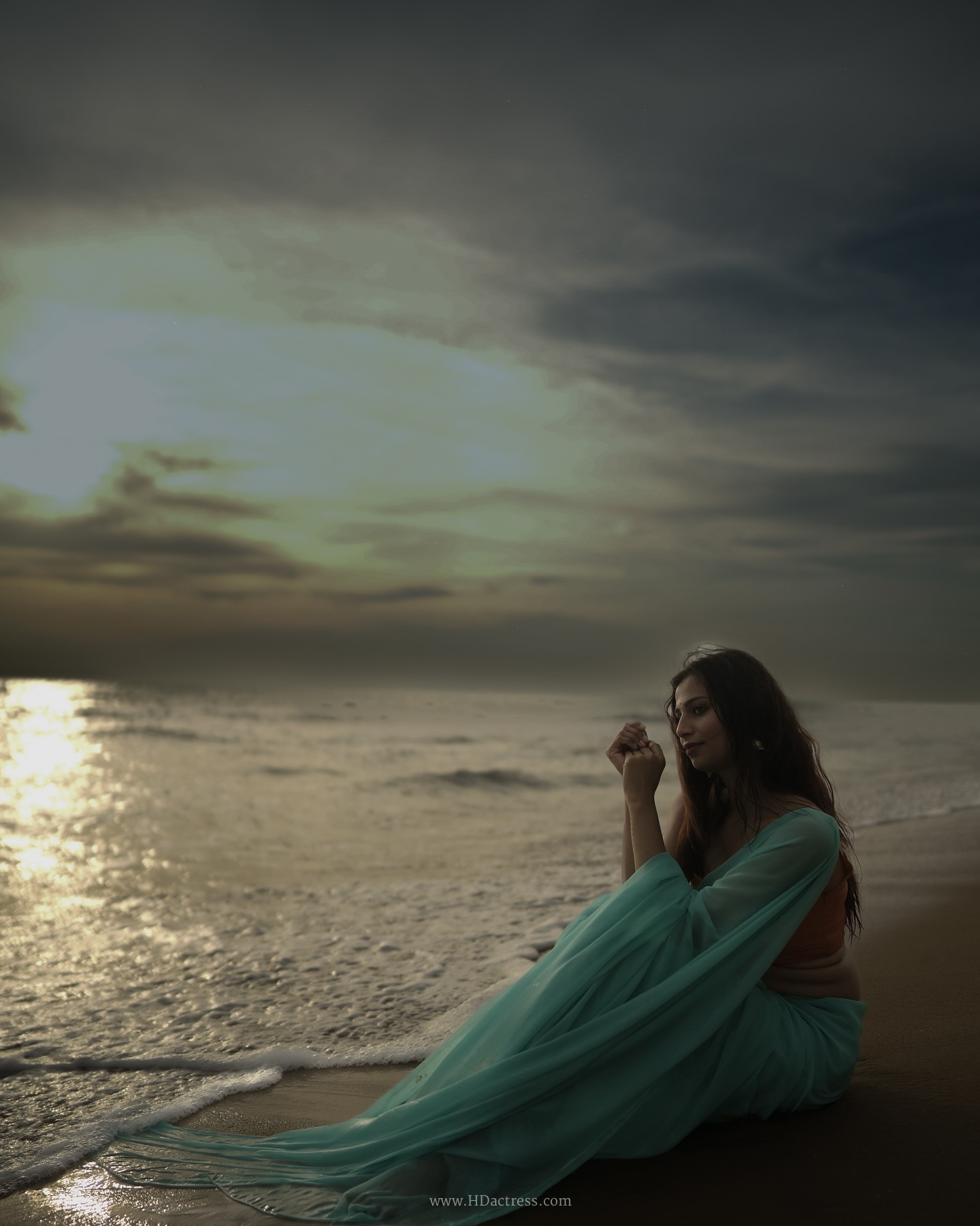 Srishti Singh wearing a mint green chiffon saree and peach-orange blouse