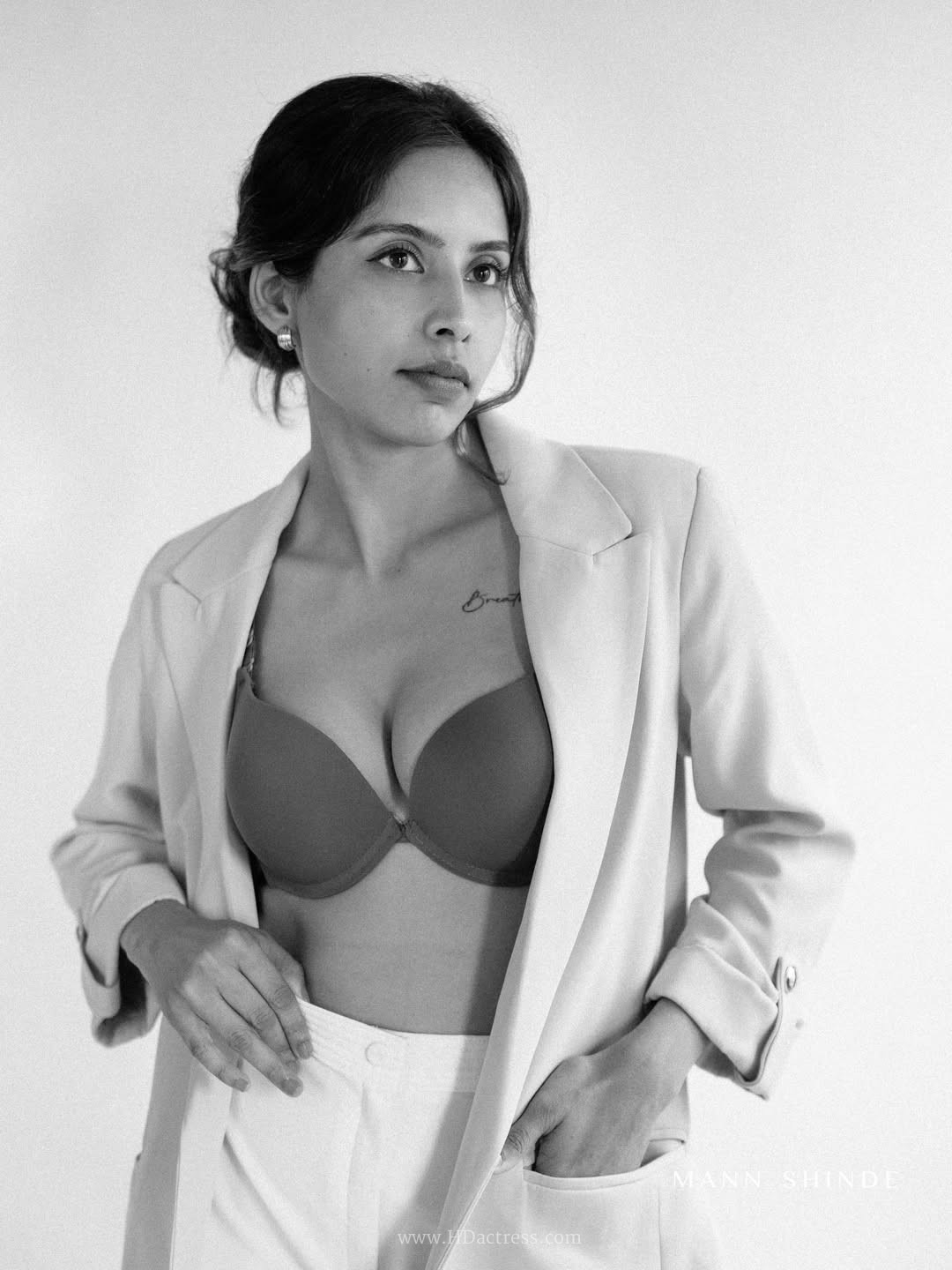 Esha Sana in a mauve top and high-waisted white trousers