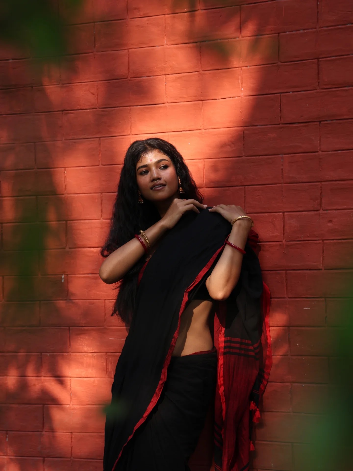 Jharna Kajol Sarkar in a black saree with red border