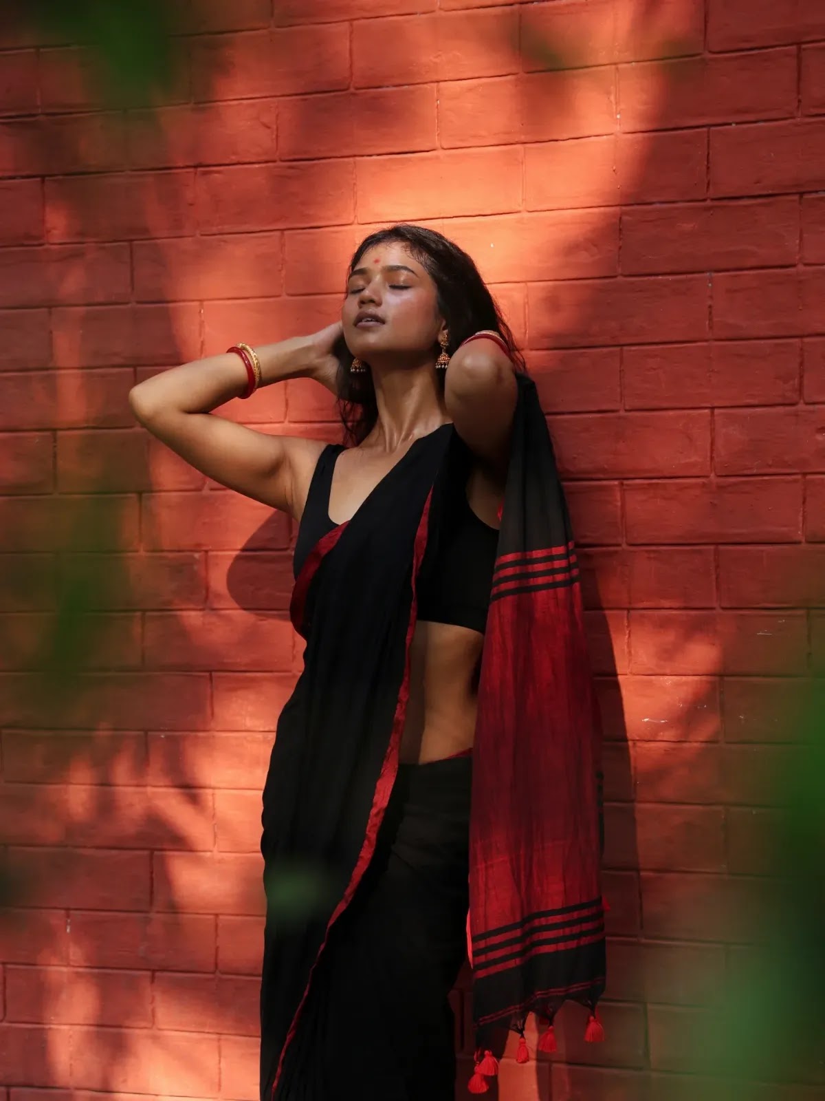 Jharna Kajol Sarkar in a black saree with red border