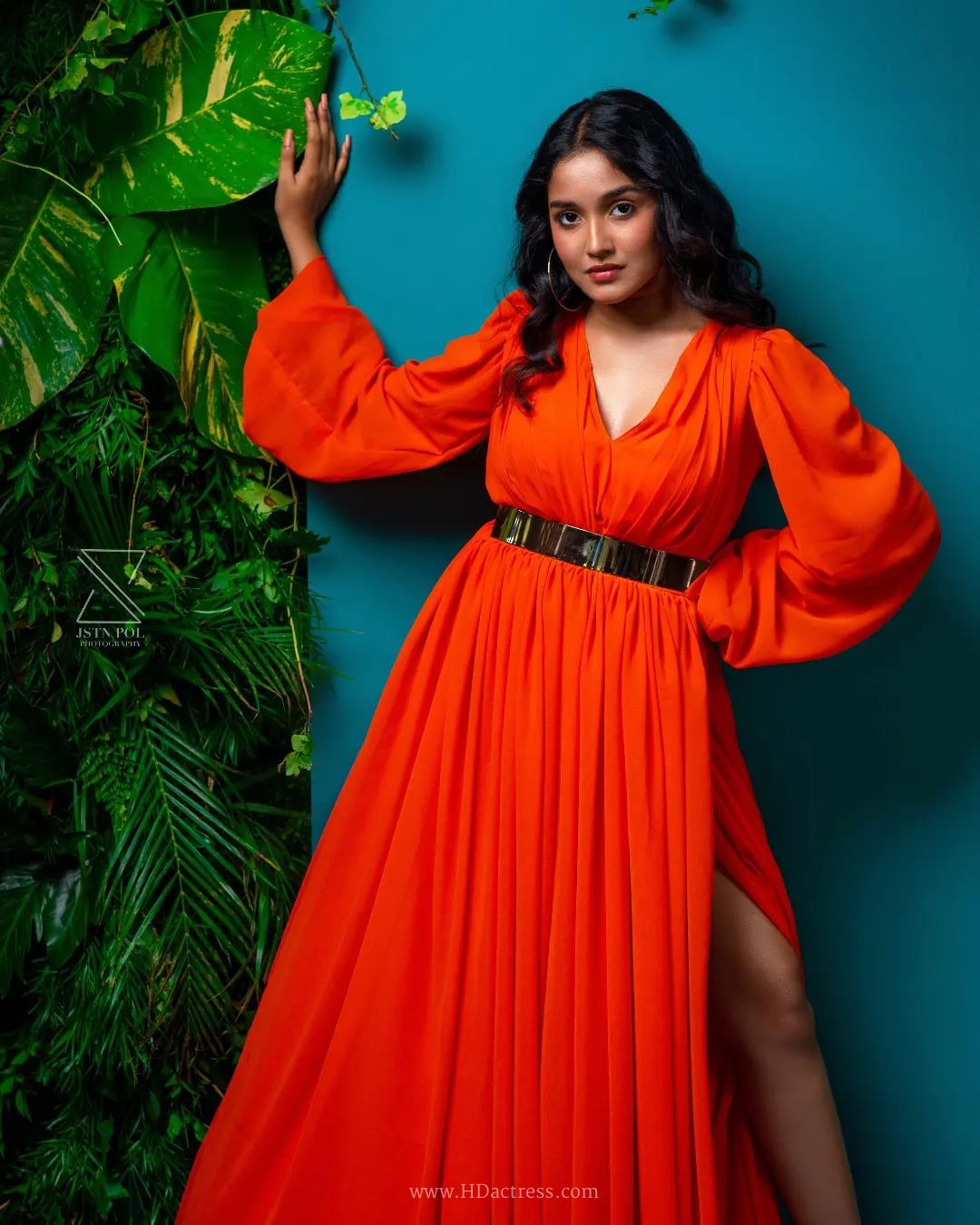 Anikha Surendran wearing vibrant orange maxi gown with billowy sleeves Anikha Surendran wearing vibrant orange maxi gown with billowy sleeves