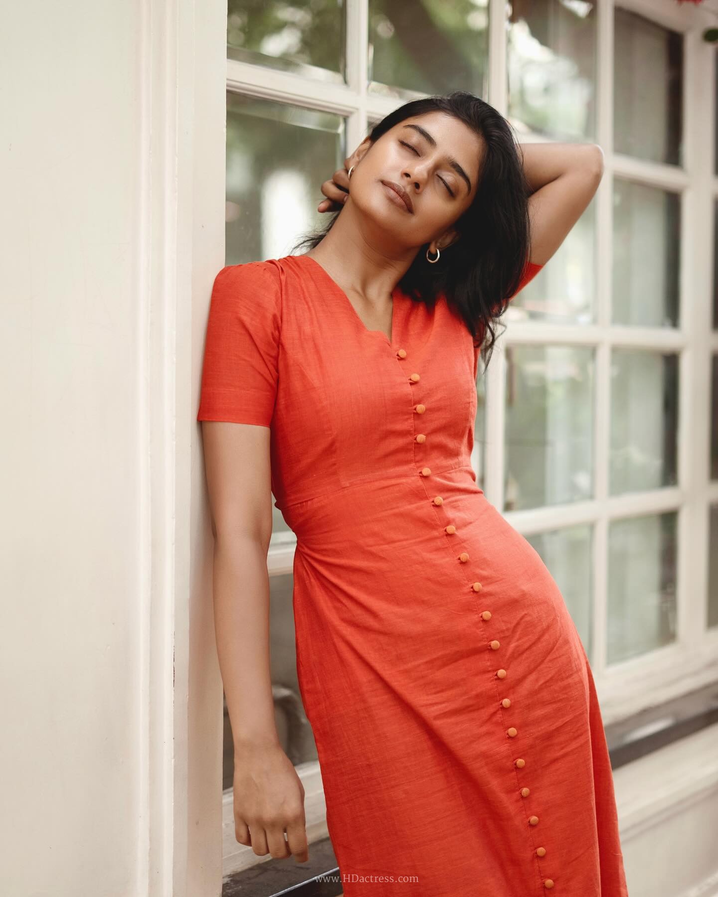 Sushmitha Bhat wearing a vibrant orange button-down maxi dress Sushmitha Bhat wearing a vibrant orange button-down maxi dress