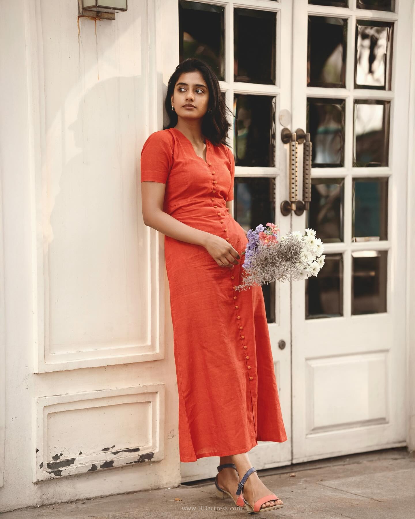 Sushmitha Bhat wearing a vibrant orange button-down maxi dress Sushmitha Bhat wearing a vibrant orange button-down maxi dress