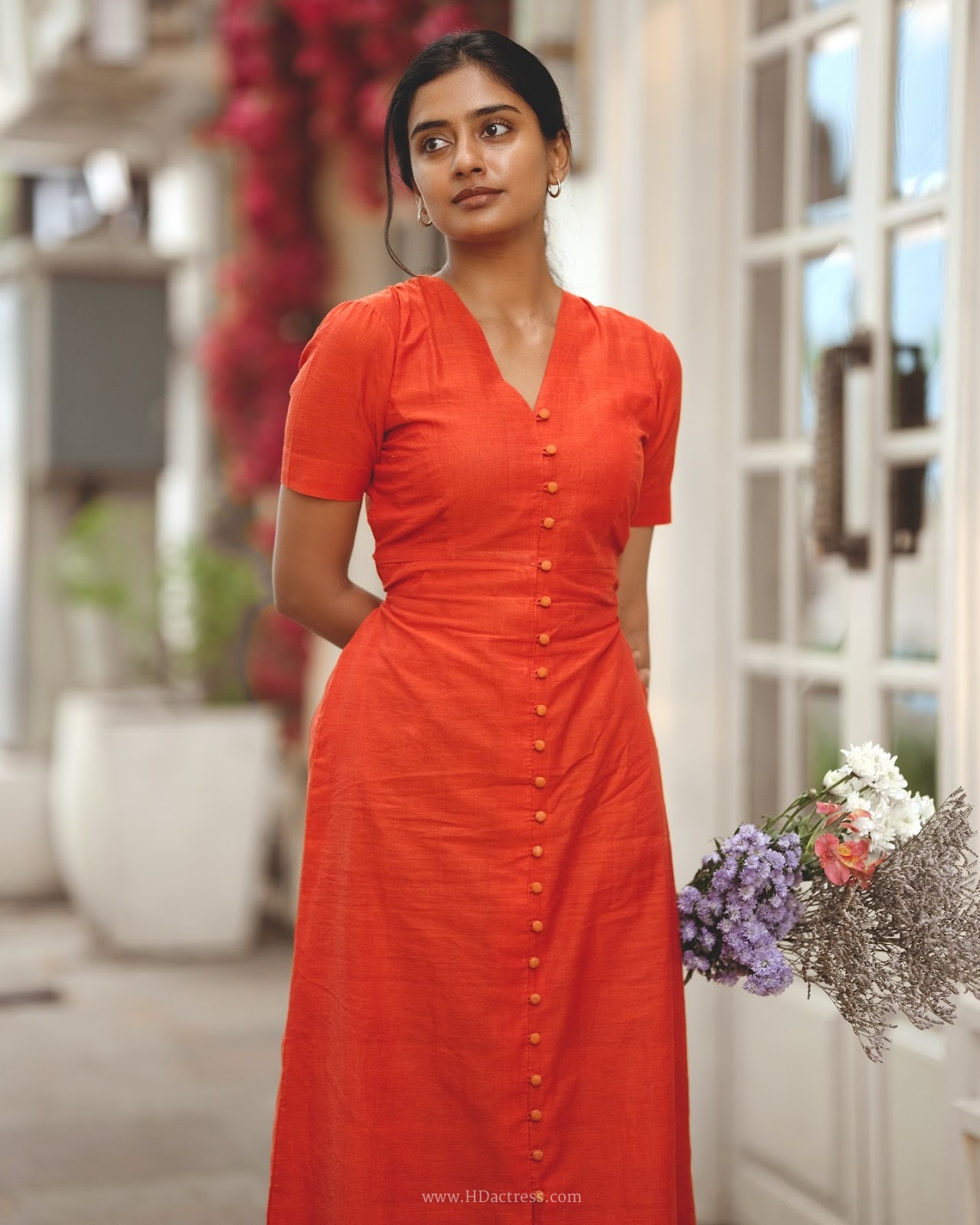 Sushmitha Bhat wearing a vibrant orange button-down maxi dress Sushmitha Bhat wearing a vibrant orange button-down maxi dress