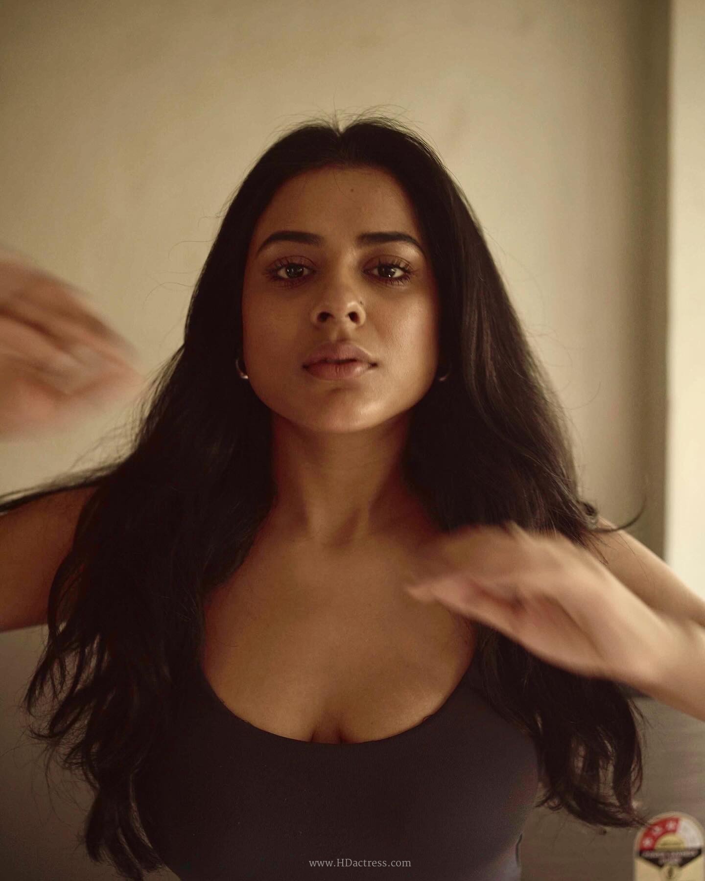 Nidhi Dudhraj wearing a charcoal grey camisole and dark blue jeans